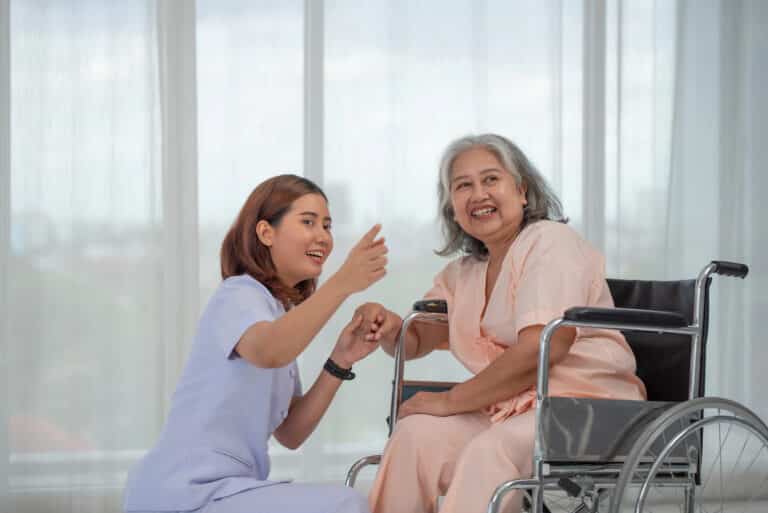 Caregiver assisting a senior with medication management during long-term home care in New Jersey.
